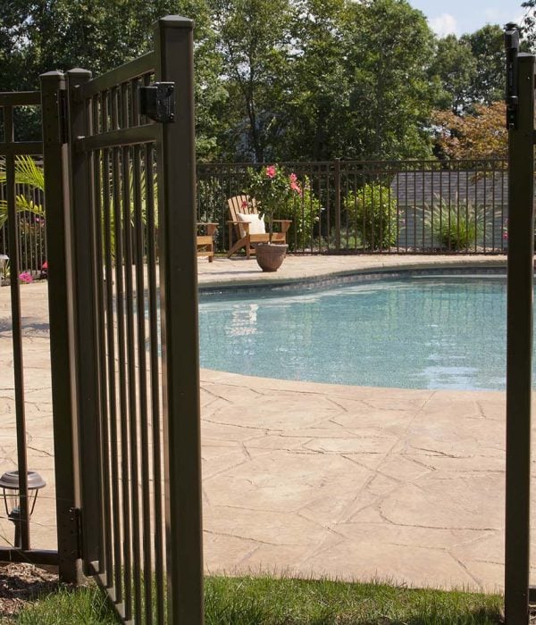 Luxury salt water pool and patio in a residential backyard.