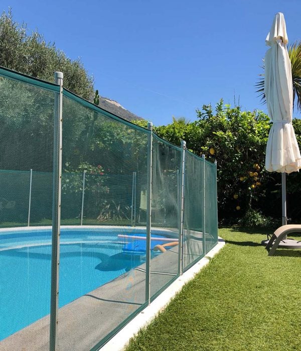 Safety fence around a small swimming pool in a back garden